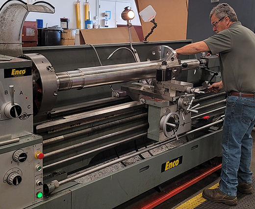 Man working on a metal lathe.