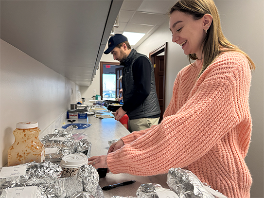 Epsilon C5I teammates prepare breakfast burritos for Valentine’s Day.